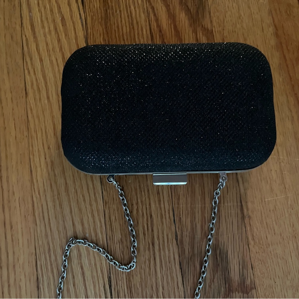 Small black evening clutch with slight shimmer. Boutique purchase.